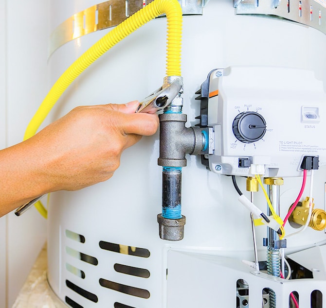 Handyman repairing a white boiling that is inside