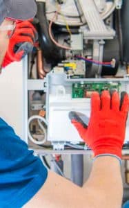 Handyman looking at the inside of an electrical box