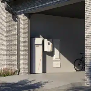 A modern garage with a bicycle and white energy storage units mounted on the wall.
